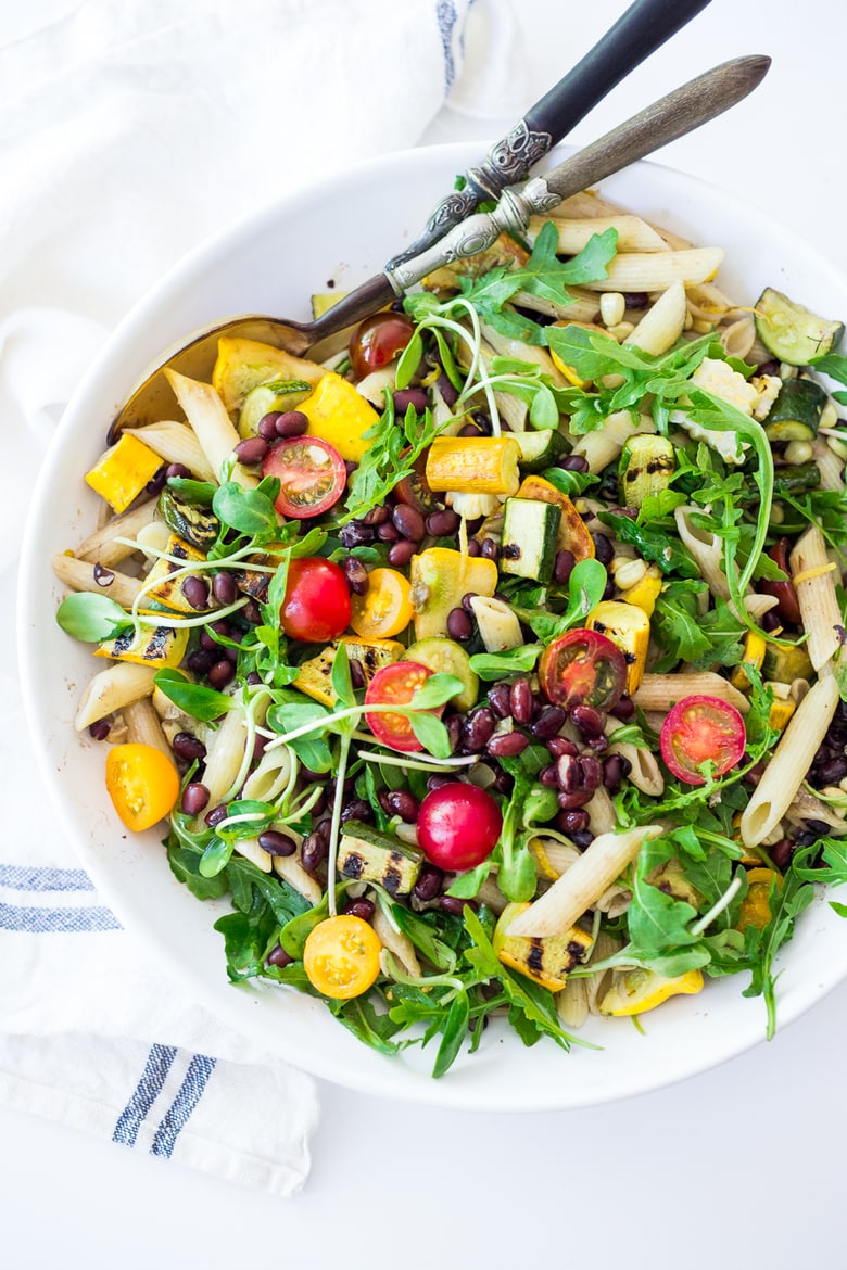 Farmers Market Pasta Salad with grilled zucchini, corn and blackbeans or other veggies! Make with optional grain-free pasta and keep it vegan or add feta. | www.feastingathome.com