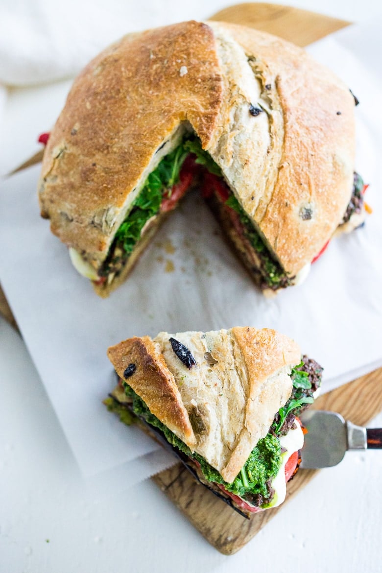 Grilled Eggplant Muffuletta Sandwich with Pesto, roasted peppers, olive tapenade and fresh mozzarella. All the flavors of summer in one bite! | www.feastingathome.com