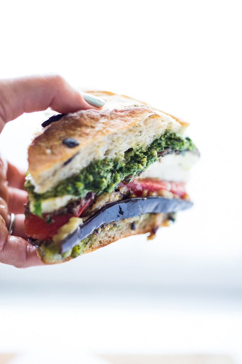Grilled Eggplant Muffuletta Sandwich with Pesto, roasted peppers, olive tapenade and fresh mozzarella. All the flavors of summer in one bite! | www.feastingathome.com