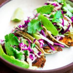 These Fish Tacos with cilantro lime taco slaw & creamy fish taco sauce can be made in under 30 minutes! Easy, healthy and full of amazing flavor!
