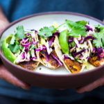 Perfect Fish Tacos with Cilantro Lime Cabbage Slaw are quick, easy, and have the BEST Flavor! Pan-sear, grill or bake in under 30 minutes. Vegan-adaptable swapping tofu for the fish! Video.