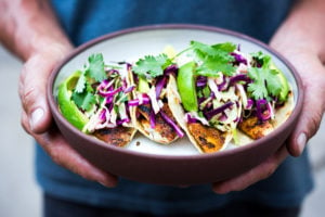 Fish Tacos with the best fish Taco Slaw. Cook on the grill, stove top or oven! Vegan & gluten-free adaptable- sub tofu for the fish! A fast, easy and healthy dinner that comes together in under 30 minutes.