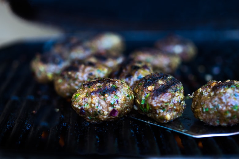 Grilled Lamb Kofta are light and delicious, and BURSTING with Middle Eastern Flavor! Served with Tzatziki, these are low carb and high in protein. | www.feastingathome.com