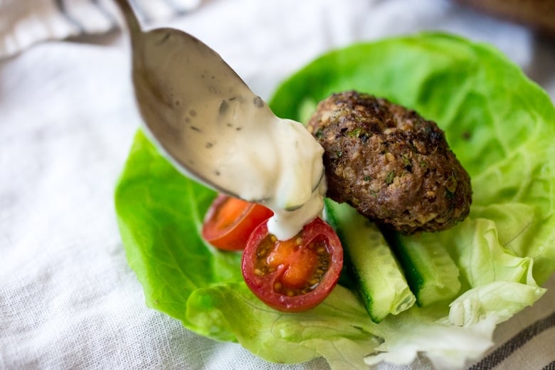 Grilled Lamb Kofta Wraps are light and delicious, and BURSTING with Middle Eastern Flavor! Served with Tzatziki, these are low carb and high in protein. | www.feastingathome.com