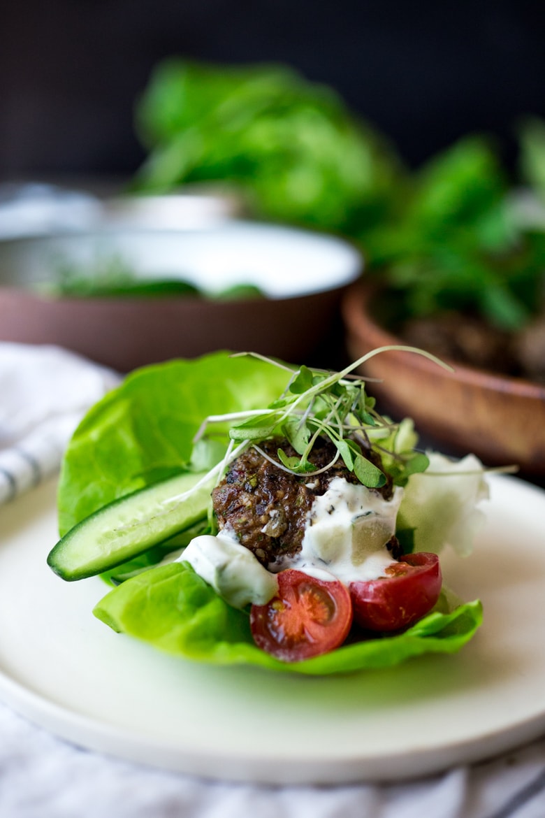 Grilled Lamb Kofta Wraps are light and delicious, and BURSTING with Middle Eastern Flavor! Served with Tzatziki, these are low carb and high in protein. | www.feastingathome.com