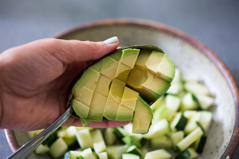 making the avocado salad. 