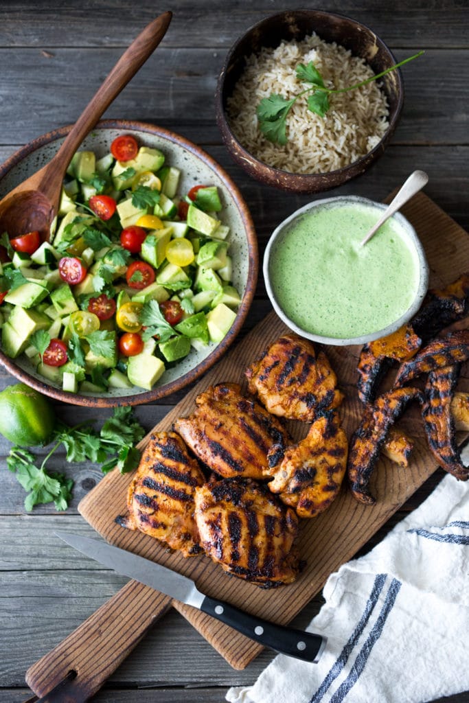 Grilled Peruvian Chicken with Cilantro Sauce and Avocado Tomato Salad - or make a vegetarian version with grilled portobellos! + 15 DELICIOUS SUMMER GRILLING RECIPES | www.feastingathome.com