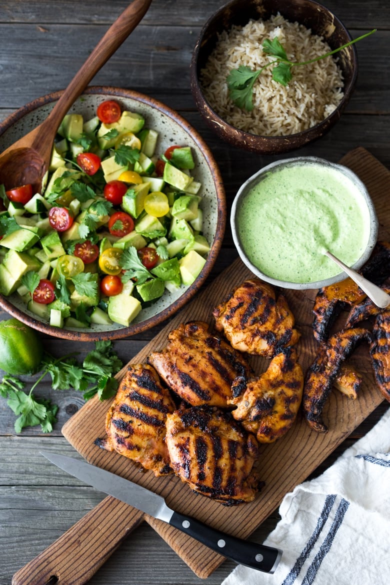Grilled Peruvian Chicken (Pollo a la Brasa) with Aji Verde (Peruvian Green Sauce)and Avocado Tomato Cucumber Salad. Can be made in 40 minutes- perfect for weeknights! 