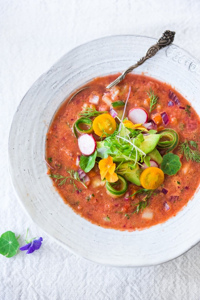 Cool and refreshing, Watermelon Gazpacho is just what the doctor ordered on hot summer days!  This cold watermelon soup is chilled, then topped with cool, crunchy cucumber, red onion, red bell pepper, avocado, microgreens, and fresh herbs; it's a treat for the senses and nourishes the body!