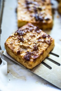 How to make Baked Tofu! A delicious source of plant-based protein perfect for salads, spring rolls, Buddha bowls, or served with a side of veggies! Vegan and Gluten-Free adaptable. | www.feastingathome.com