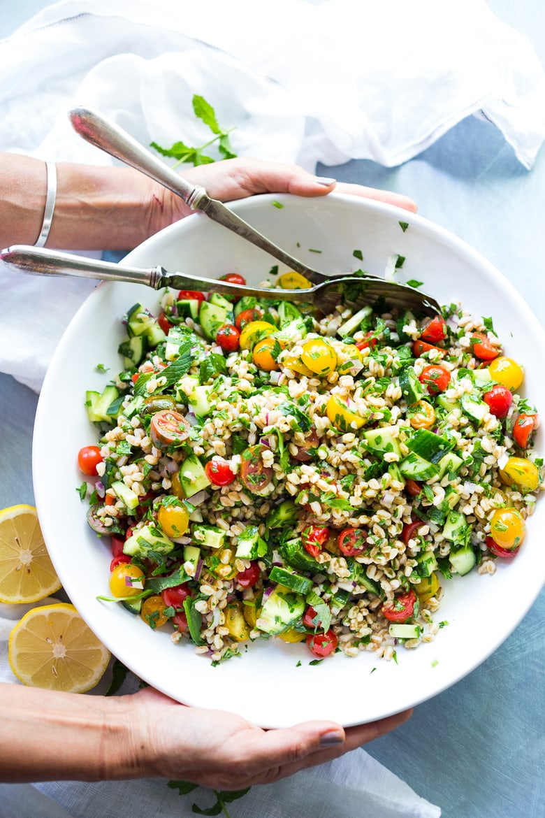 A simple & delicious recipe for Farro Tabbouleh Salad, made with finely chopped vegetables, fresh herbs, lemon and olive oil. Vegan! | www.feastingathome.com