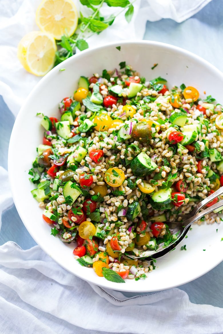 A simple & delicious recipe for Farro Tabbouleh Salad, made with finely chopped vegetables, fresh herbs, lemon and olive oil. Vegan! | www.feastingathome.com