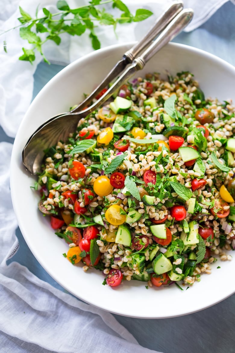 A simple & delicious recipe for Farro Tabbouleh Salad, made with finely chopped vegetables, fresh herbs, lemon and olive oil. Vegan! | www.feastingathome.com