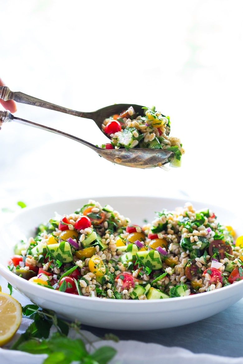 A simple & delicious recipe for Farro Tabbouleh Salad, made with finely chopped vegetables, fresh herbs, lemon and olive oil. Vegan! | www.feastingathome.com