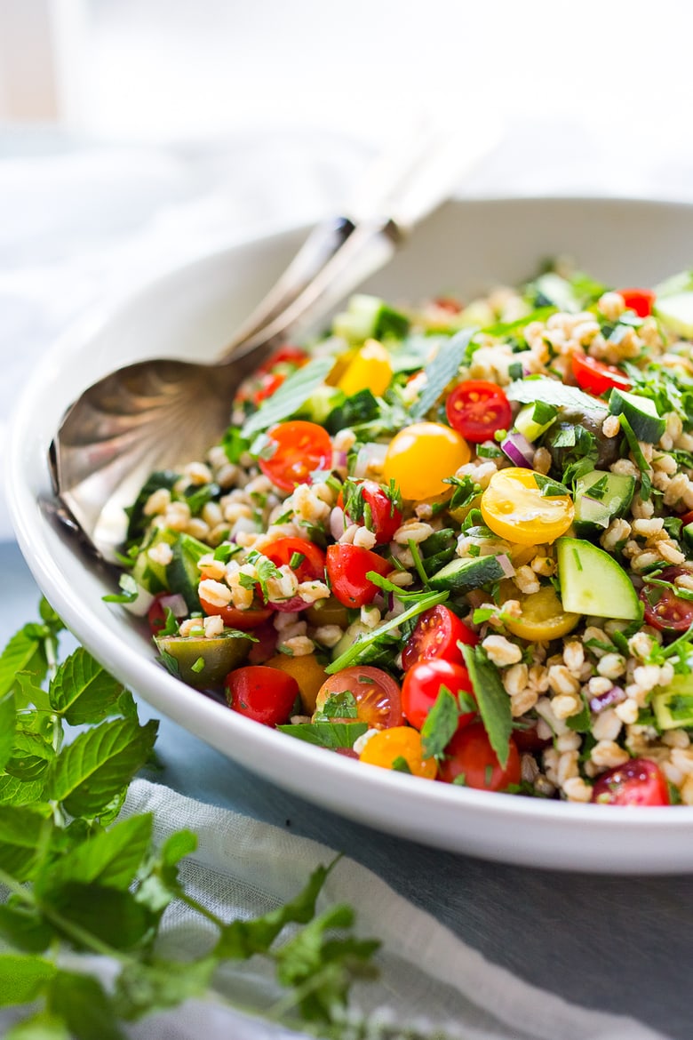 A simple & delicious recipe for Farro Tabbouleh Salad, made with finely chopped vegetables, fresh herbs, lemon and olive oil. Vegan! | www.feastingathome.com