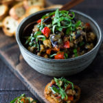 This Sicilian recipe for Eggplant Caponata- is simple, easy and full of summer flavor! Serve it as a healthy vegan appetizer over crostini, or as a delicious side dish, or turn it into an eggplant "salad" served over greens and grains! Low- Carb  and Vegan! #eggplantrecipes #eggplantcaponata #caponata #feastingathome #grilledeggplant #vegan #healthy