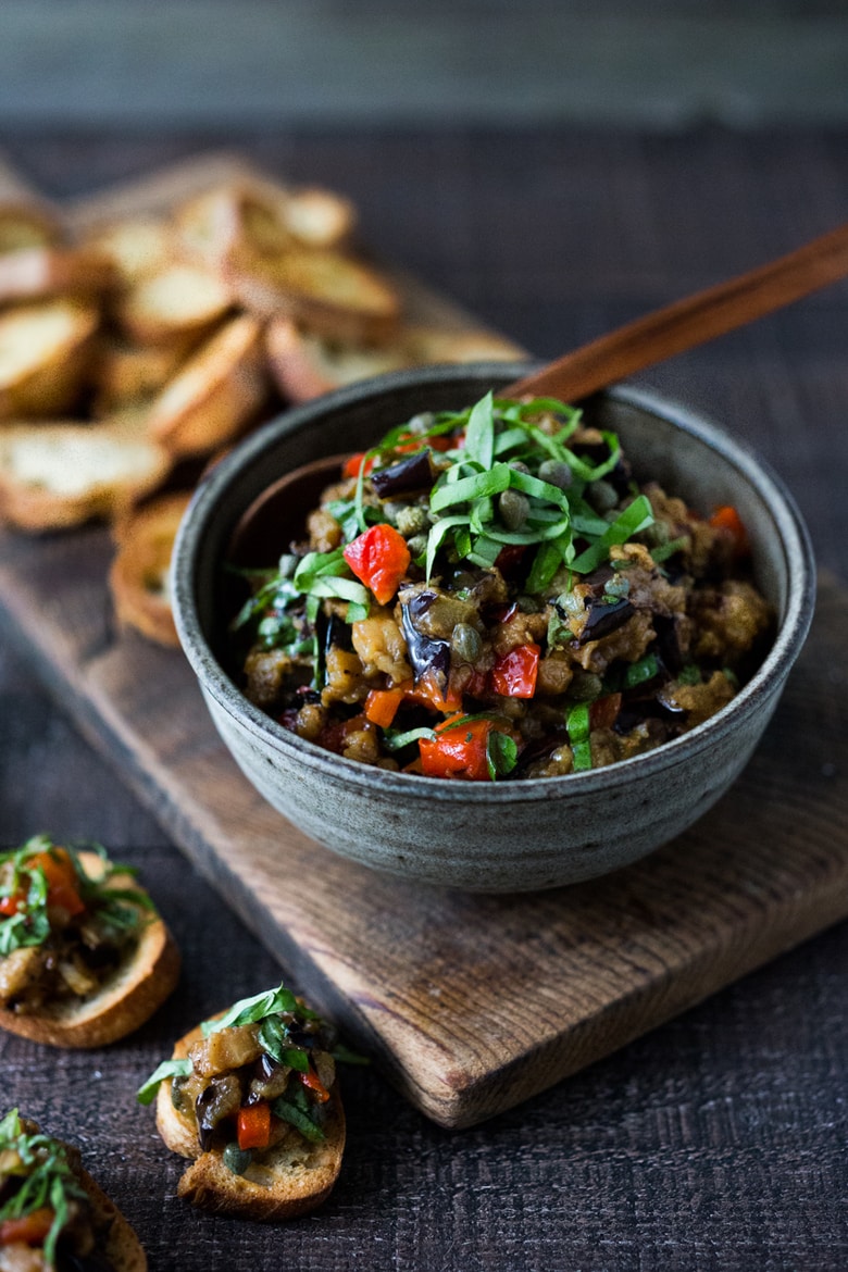 This Sicilian recipe for Eggplant Caponata- simple, easy and full of summer flavor! Serve it as a healthy vegan appetizer over crostini, or as a delicious side dish, or turn it into an eggplant "salad" served over greens and grains! Low- Carb  and Vegan! 