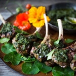 Grilled Lamb Lollipops with an Italian herb sauce called Salsa Verde. Bursting with incredible Mediterranean flavors, serve this as an appetizer or main course. | www.feastingathome.com