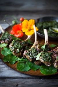 Grilled Lamb Lollipops with an Italian herb sauce called Salsa Verde. Bursting with incredible Mediterranean flavors, serve this as an appetizer or main course. | www.feastingathome.com