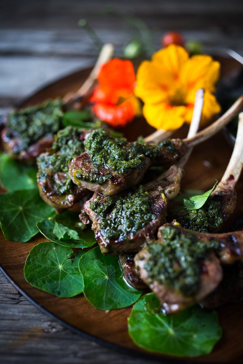 Grilled Lamb Lollipops with Salsa Verde - grilled single lamb chops topped with the most flavorful Italian Herb Caper Sauce, called Salsa Verde. Serve as a a quick, easy appetizer. Fast, flavorful and so delicious! | www.feastingathome.com