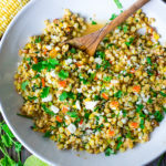 Mexican Street Corn with chilies, cilantro and lime - also called Elotes. This lighter version can be grilled or sautéed and can easily be made vegan! | www.feastingathome.com
