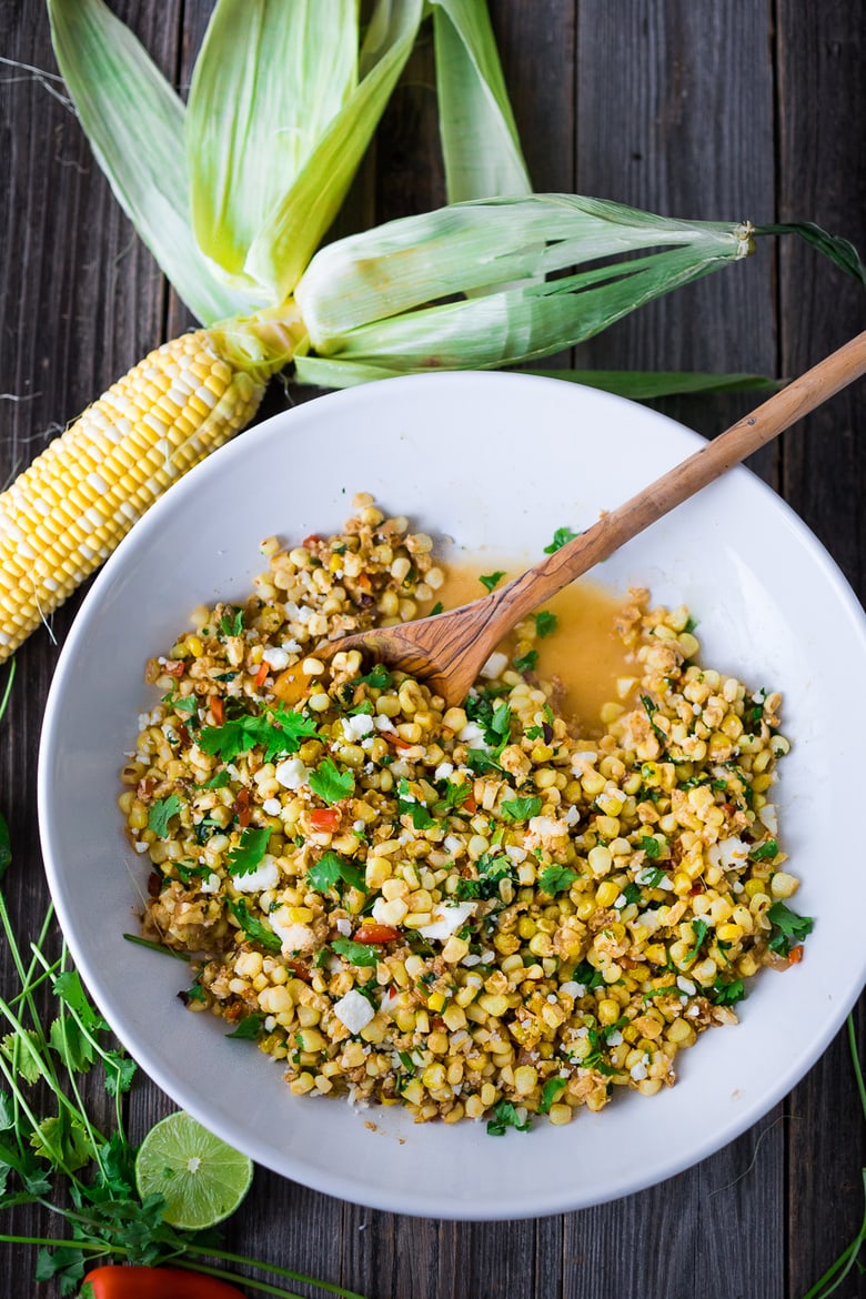 Elote Recipe - Mexican Street Corn with chilies, cilantro and lime. This lighter version can be grilled or sautéed and can easily be made vegan! | #elote #elotes #streetcorn #mexicanstreetcorn www.feastingathome.com 