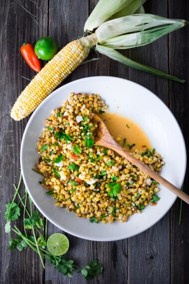 Mexican Street Corn with chilies, cilantro and lime - also called Elotes. This lighter version can be grilled or sautéed and can easily be made vegan! | www.feastingathome.com
