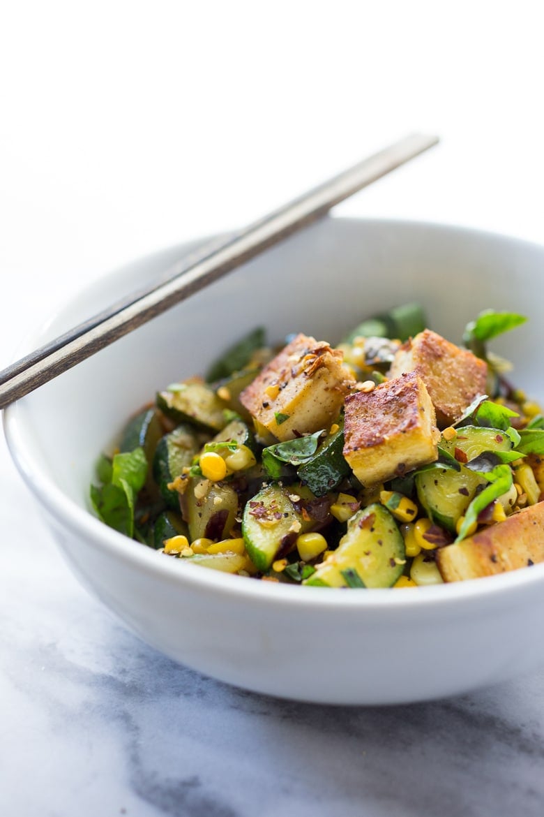 A fast and healthy dinner -Zucchini, Corn and Basil Skillet topped with your choice of shrimp, tofu or chicken. Simple and adaptable. Vegan, Gluten-free! | www.feastingathome.com