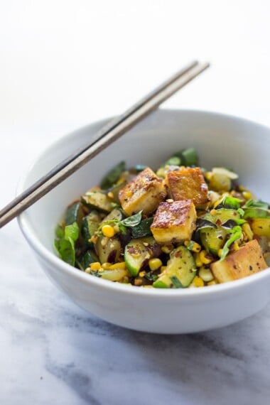 A fast and healthy dinner- Zucchini Stir-Fry with corn, basil and chili flakes, topped with your choice of shrimp, crispy tofu or chicken. Simple and adaptable. Vegan, Gluten-free!
