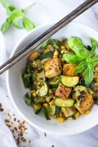 A fast and healthy dinner- Zucchini Stir-Fry with corn, basil and chili flakes, topped with your choice of shrimp, crispy tofu or chicken. Simple and adaptable. Vegan, Gluten-free!