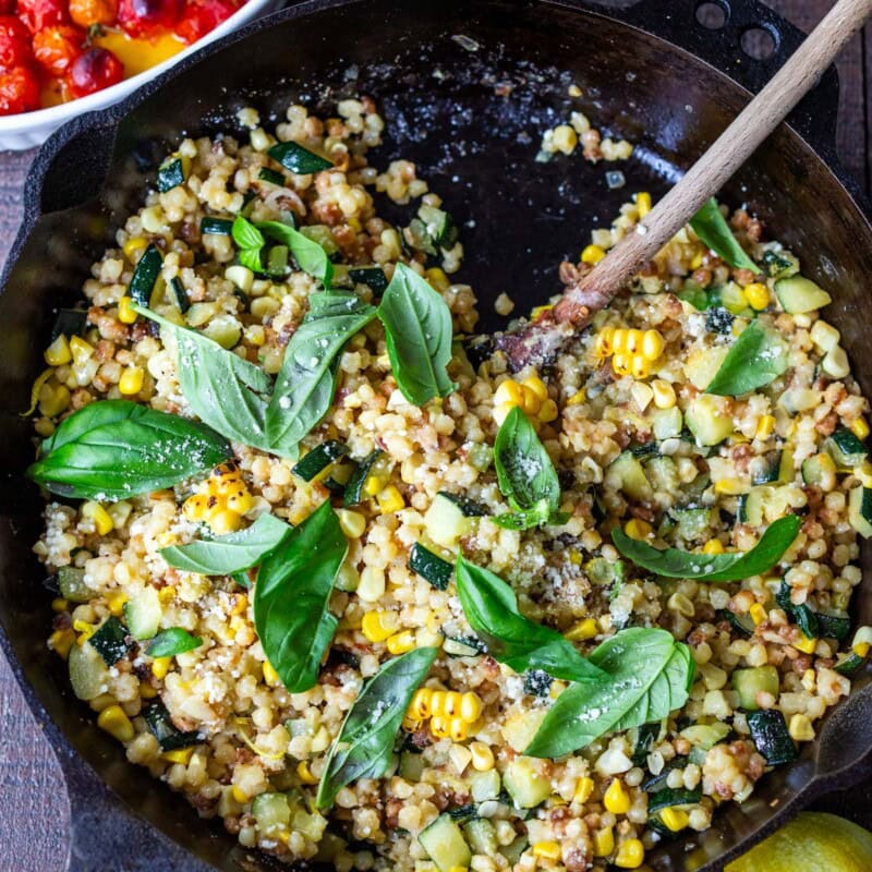 In this recipe for Fregola pasta, summer corn, and zucchini are paired with basil, pecorino, and lemon zest- a cozy, end-of-summer meal.