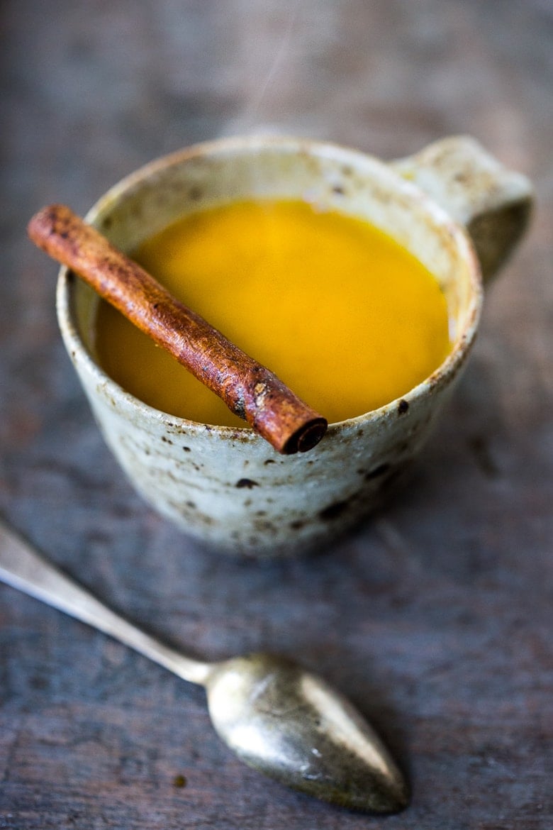 Jamu Juice- Bali's all-natural, anti-inflammatory elixir- made with fresh turmeric, ginger, honey and a squeeze of lemon. Heals and soothes the body! Make a big batch and serve hot or cold during the busy workweek! #turmeric #turmerictea | www.feastingathome.com