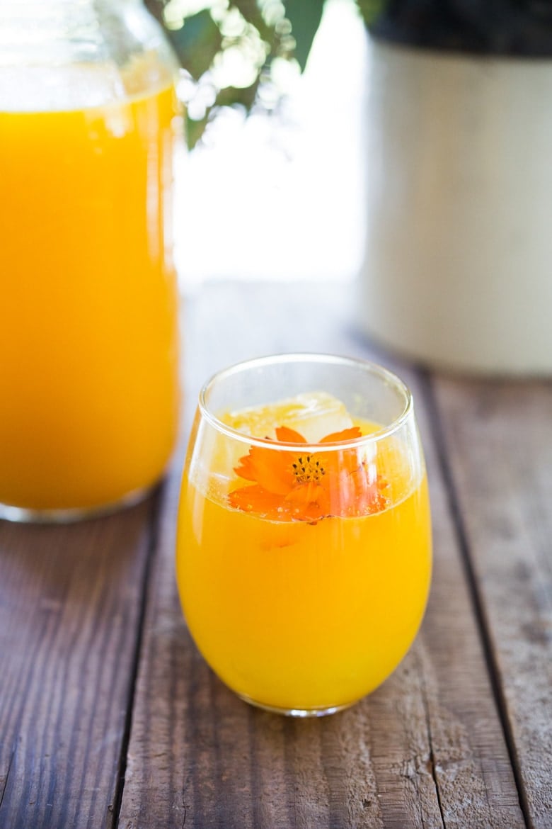 Jamu Juice- Bali's all-natural, anti-inflammatory elixir- made with fresh turmeric, ginger, honey and a squeeze of lemon. Heals and soothes the body! Make a big batch and serve hot or cold during the busy workweek! #turmeric #turmerictea | www.feastingathome.com