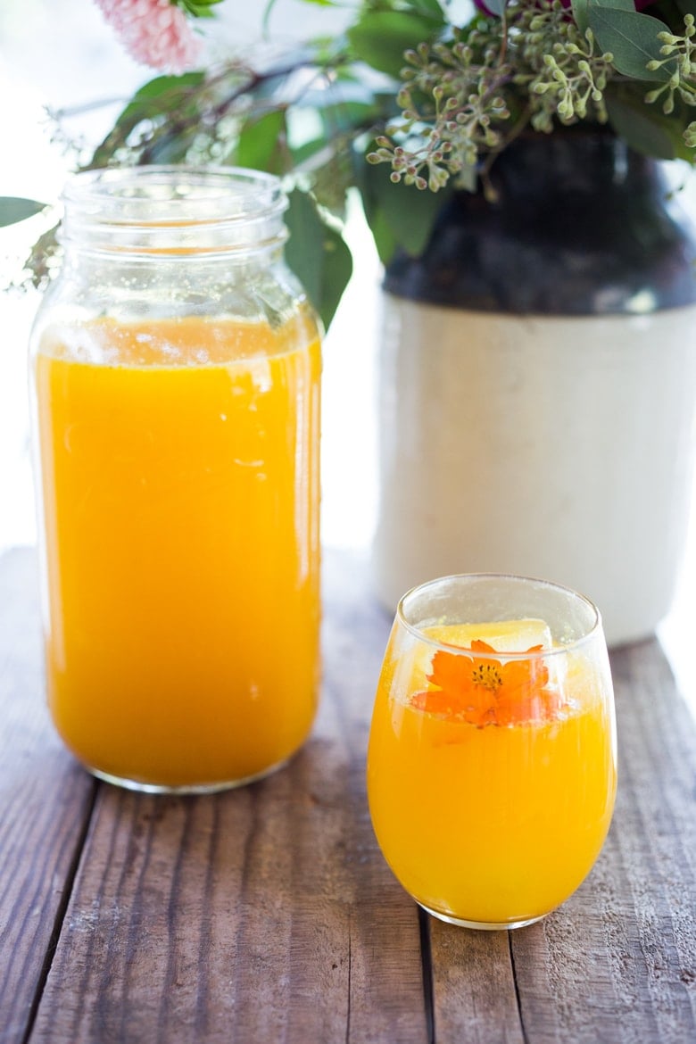 Jamu Juice- Bali's all-natural, anti-inflammatory elixir- made with fresh turmeric, ginger, honey and a squeeze of lemon. Heals and soothes the body! Make a big batch and serve hot or cold during the busy workweek! #turmeric #turmerictea | www.feastingathome.com
