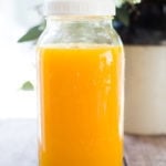 Jamu Juice- Bali's all-natural, anti-inflammatory elixir- made with fresh turmeric, ginger, honey and a squeeze of lemon. Heals and soothes the body! Make a big batch and serve hot or cold during the busy workweek! #turmeric #turmerictea | www.feastingathome.com