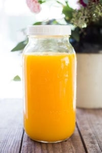 Jamu Juice- Bali's all-natural, anti-inflammatory elixir- made with fresh turmeric, ginger, honey and a squeeze of lemon. Heals and soothes the body! Make a big batch and serve hot or cold during the busy workweek! #turmeric #turmerictea | www.feastingathome.com