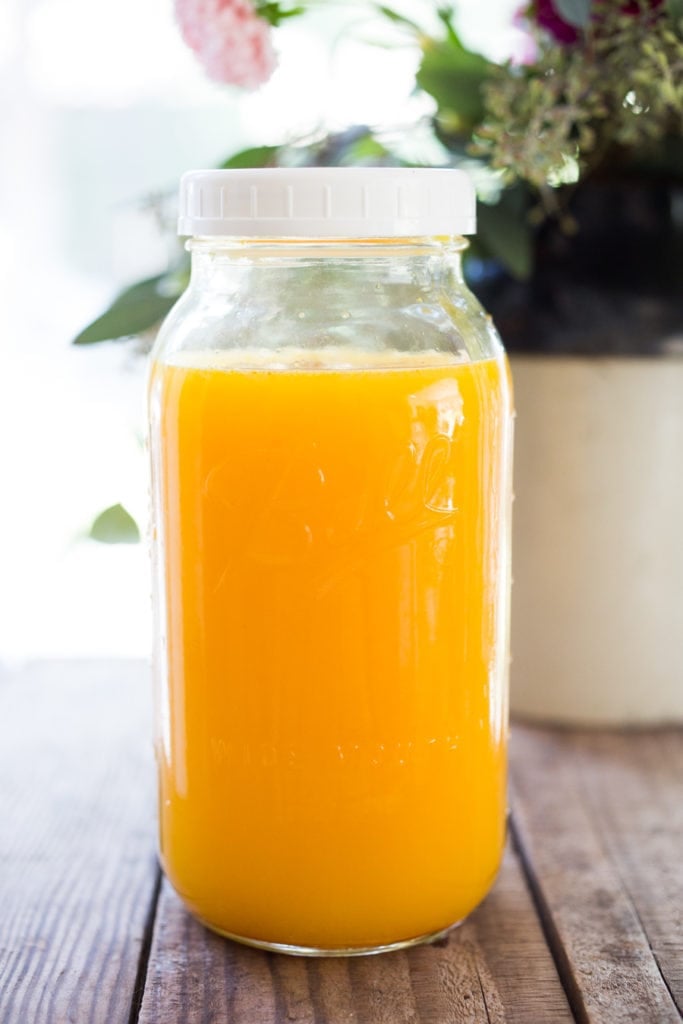 Jamu Juice- Bali's all-natural, anti-inflammatory elixir- made with fresh turmeric, ginger, honey and a squeeze of lemon. Heals and soothes the body! Make a big batch and serve hot or cold during the busy workweek! #turmeric #turmerictea | www.feastingathome.com