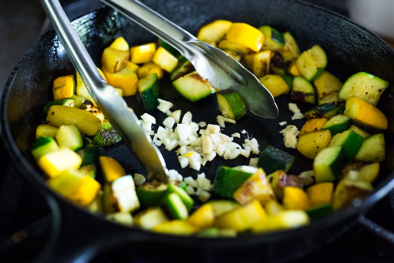 A simple delicious recipe for Kung Pao Zucchini over noodles or rice. Vegan and gluten-free adaptable! | www.feastingathome.com 