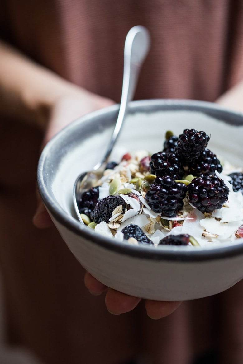 A bowl of muesli with fresh blackberries 