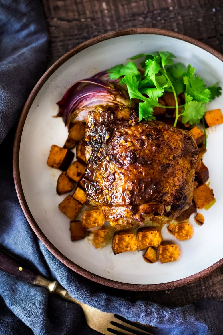 Sheet-Pan Harissa Chicken and roasted Sweet Potatoes- just 15 minutes of hands on time, before baking in the oven. Smoky, earthy, fragrant, North African Spices ! #harissa #harissachicken #chicken # sheetpandinner | www.feastingathome.com