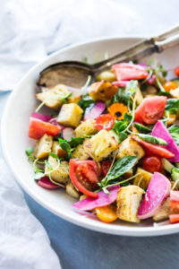 A simple delicious recipe for Summer Panzanella Salad with Garlicky Croutons, bursting with fresh seasonal summer ingredients and FLAVOR! | www.feastingathome.com