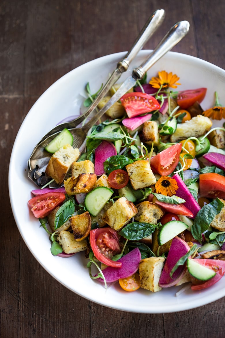 A simple delicious recipe for Summer Panzanella Salad with Garlicky Croutons, bursting with fresh seasonal summer ingredients and FLAVOR! | www.feastingathome.com