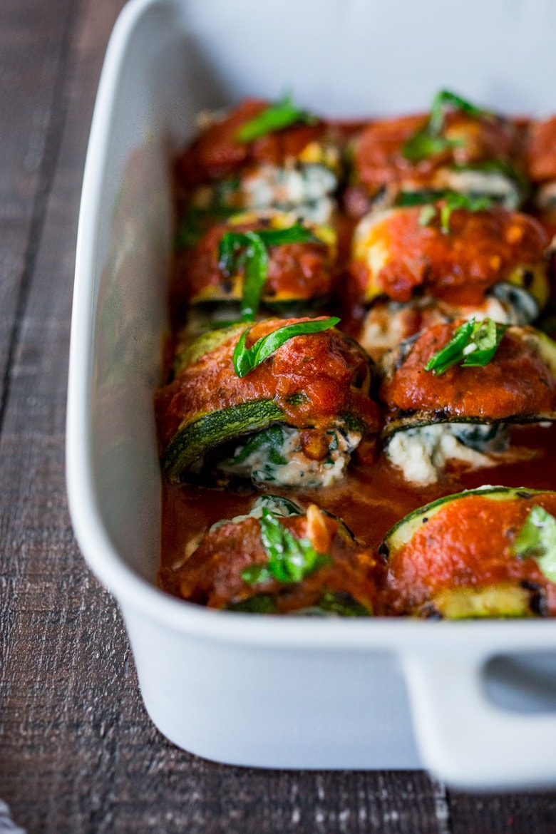 Zucchini Rolls with Spinach and Basil, baked in marinara sauce and topped with optional smoked mozzarella.| www.feastingathome.com 