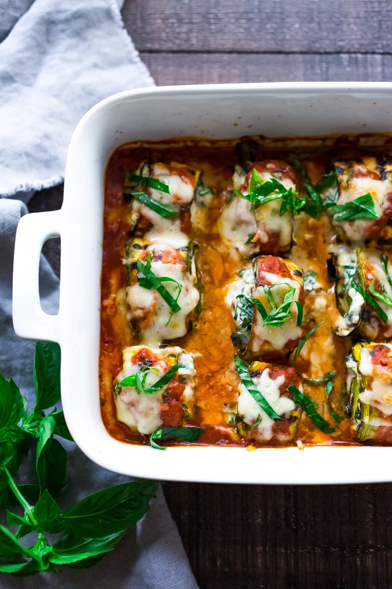 Zucchini Rolls with Spinach and Basil, baked in marinara sauce and topped with optional smoked mozzarella.| www.feastingathome.com 