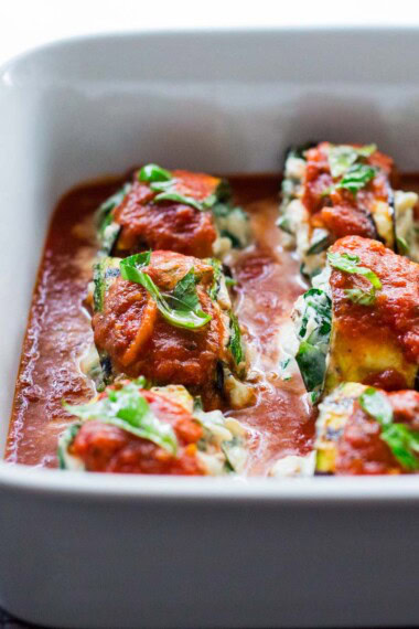 This zucchini roll-ups recipe is made with tender zucchini, spinach, ricotta, and basil, and baked in flavorful tomato sauce. Low-carb, gluten-free, vegan-adaptable. Video!