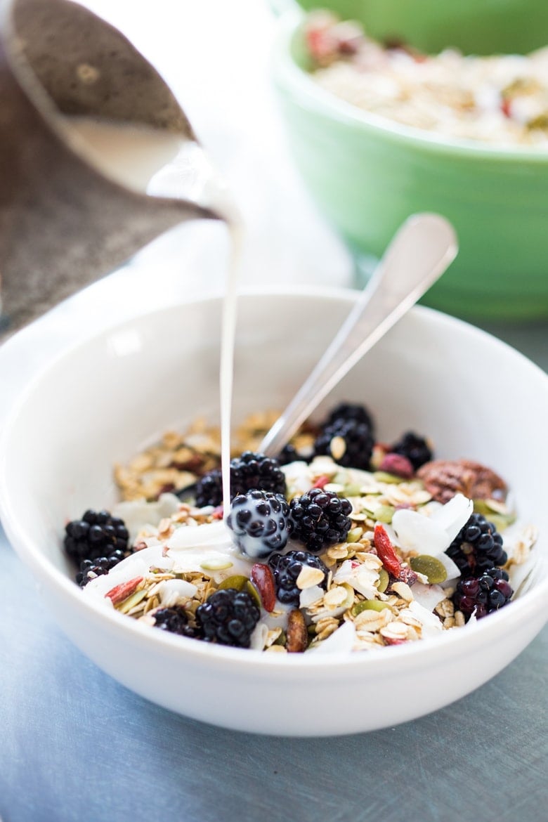 pouring milk over the muesli.