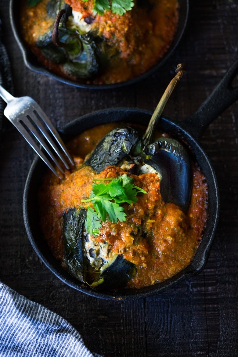 A healthy, vegan adaptable, Roasted Chiles Rellenos Recipe - that is lightened up with the addition of black beans. Simplified by roasting (instead of frying) the peppers with the Salsa Ranchero Sauce ingredients - all baked together on one sheet-pan - saving a step!  #chiliesrancheros 