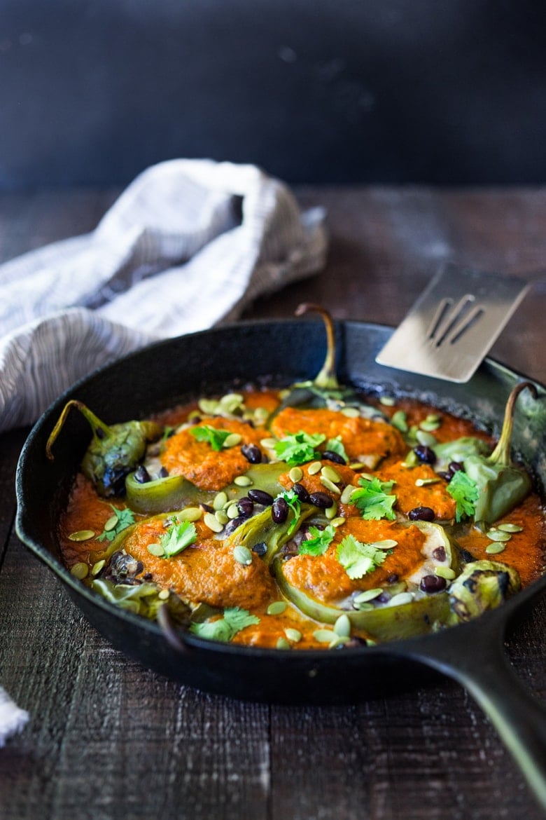 A healthy, vegan adaptable, Roasted Chiles Rellenos Recipe - that is lightened up with the addition of black beans. Simplified by roasting (instead of frying) the peppers with the Salsa Ranchero Sauce ingredients - all baked together on one sheet-pan - saving a step!  #chiliesrancheros 