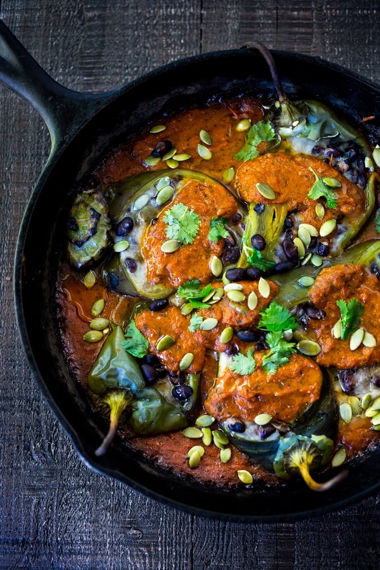 A healthy, vegan adaptable, Roasted Chiles Rellenos Recipe - that is lightened up with the addition of black beans. Simplified by roasting (instead of frying) the peppers with the Salsa Ranchero Sauce ingredients - all baked together on one sheet-pan - saving a step!  #chiliesrancheros 