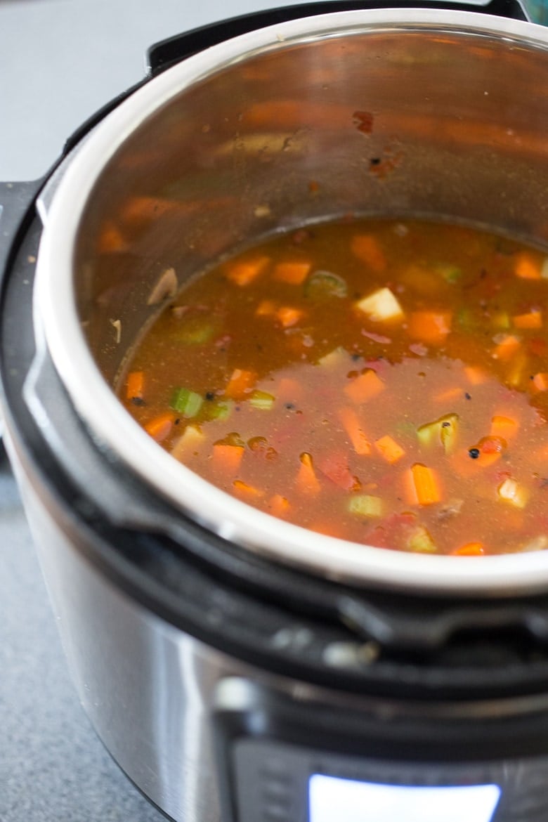 Add the broth, lentils, tomatoes and spices for the instant pot lentil soup.